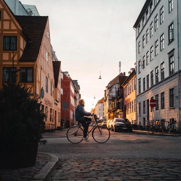 Girl biking in the neighbourhood of Christianshavn in Copenhagen