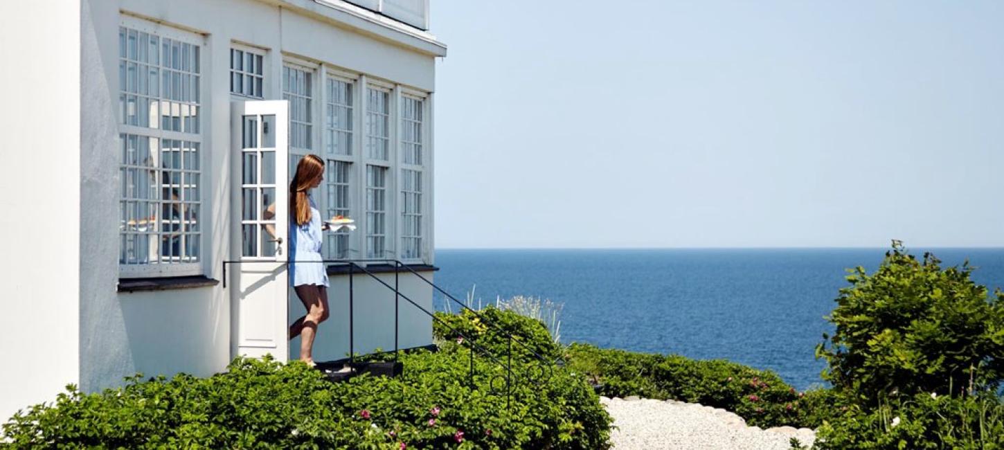 A woman walks out of Helenekilde Badehotel in North Zealand, Denmark