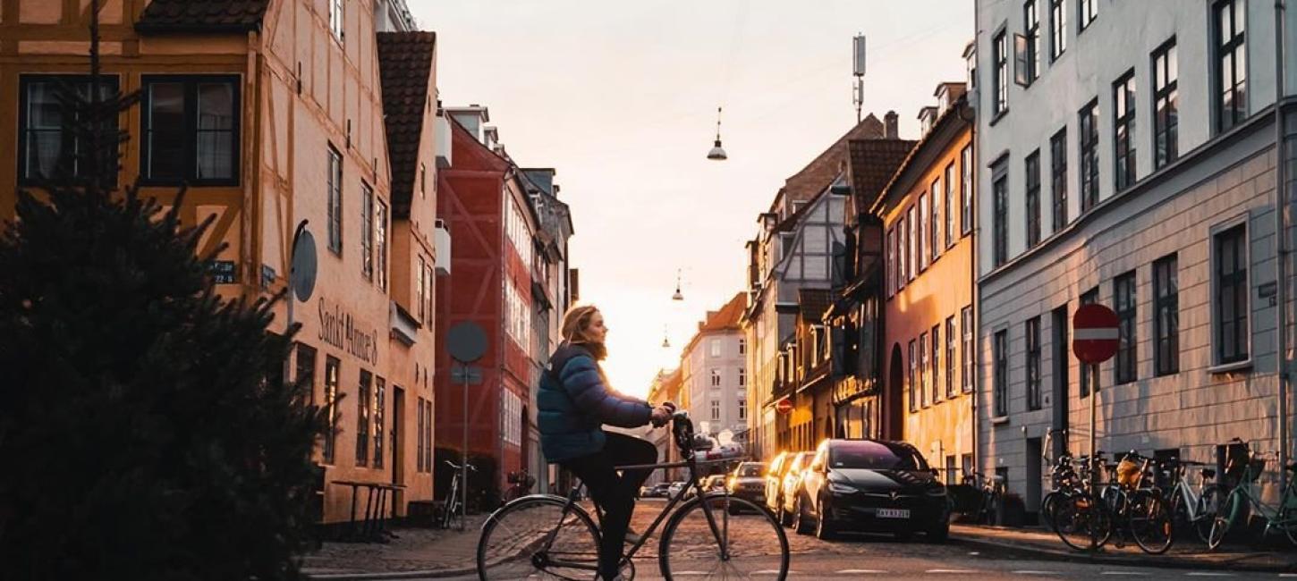 Girl biking in the neighbourhood of Christianshavn in Copenhagen