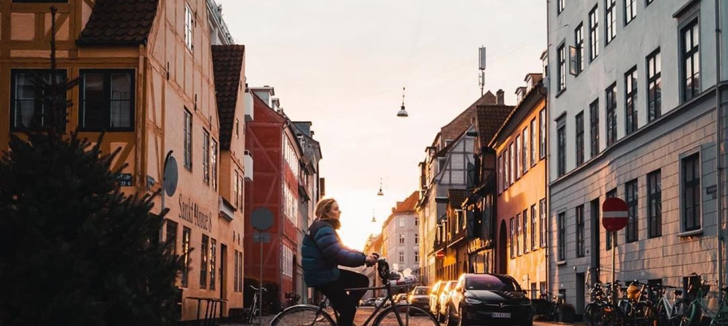 Girl biking in the neighbourhood of Christianshavn in Copenhagen