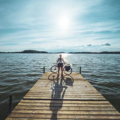 Cyclist standing at Soendersoe lake in Maribo, Lolland-Falster