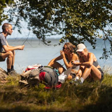 People on a hike on Danish Island Fyn taking a break at the coast