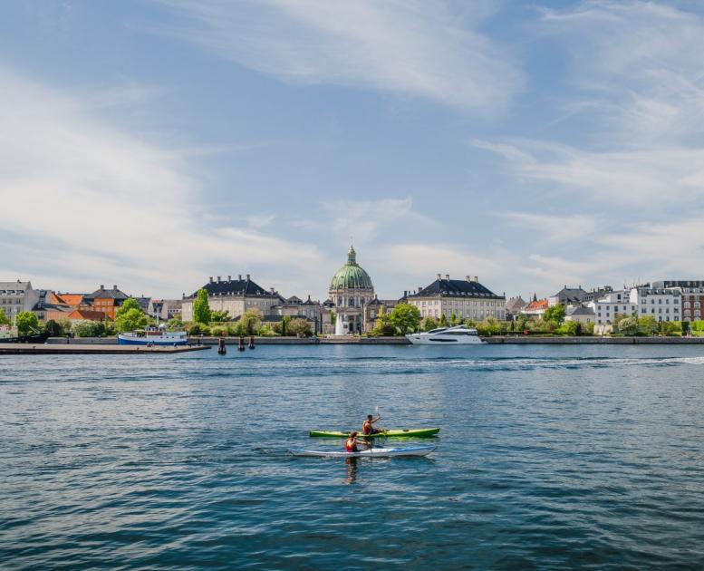 Kayaks in front of Amalienborg Castle in the harbour of Copenhagen, Denmark